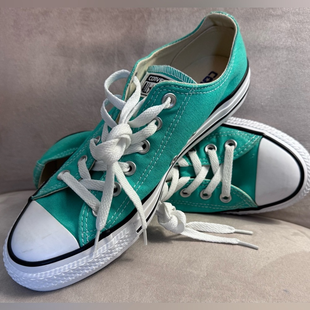 Never worn, low top, aqua green Converse. Mens size 6, women’s size 8